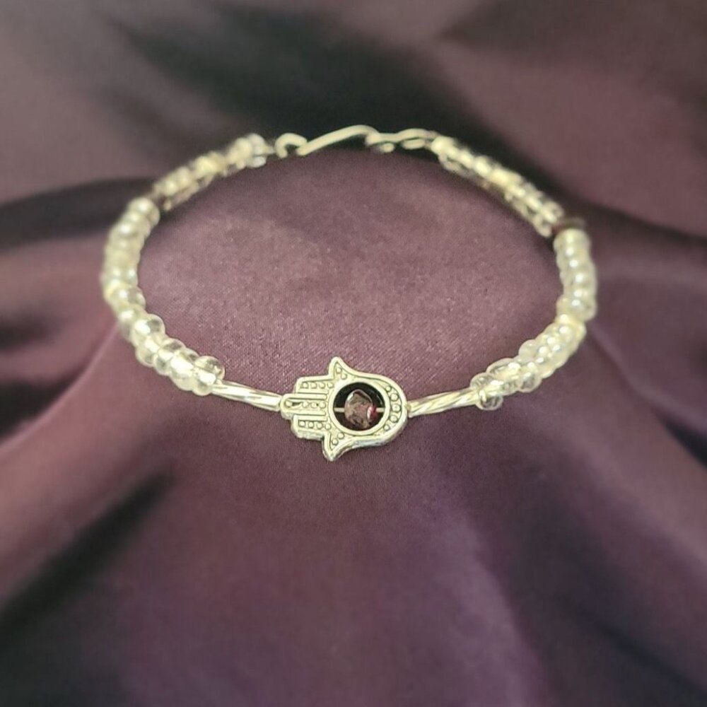 Garnet in the palm of the Hamsa hand bracelet